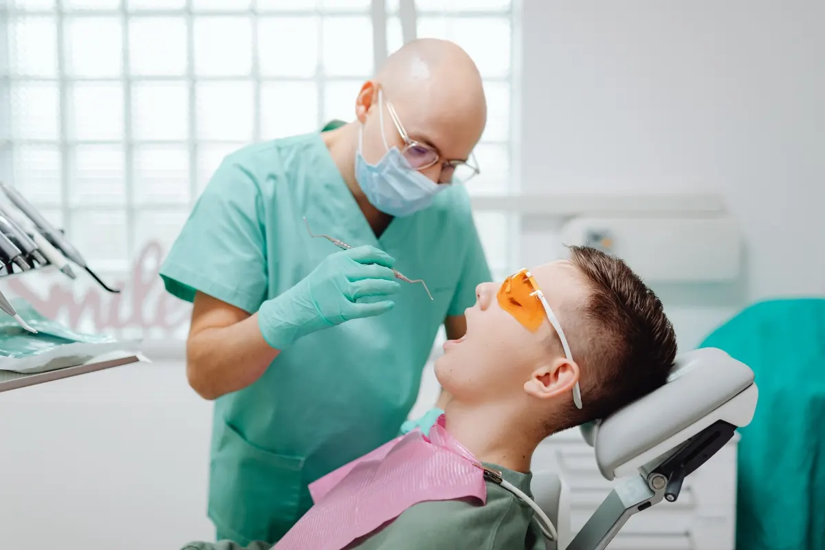 Dentist Howell checking a young patient's teeth after Halloween – dental sealants and checkups for kids