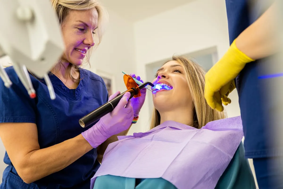 Dentist Howell in-office teeth whitening treatment with a curing light before the holidays